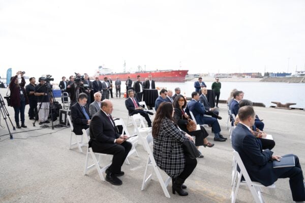 group of people sitting in chairs with media in the background during the engineering & public works roadshow event