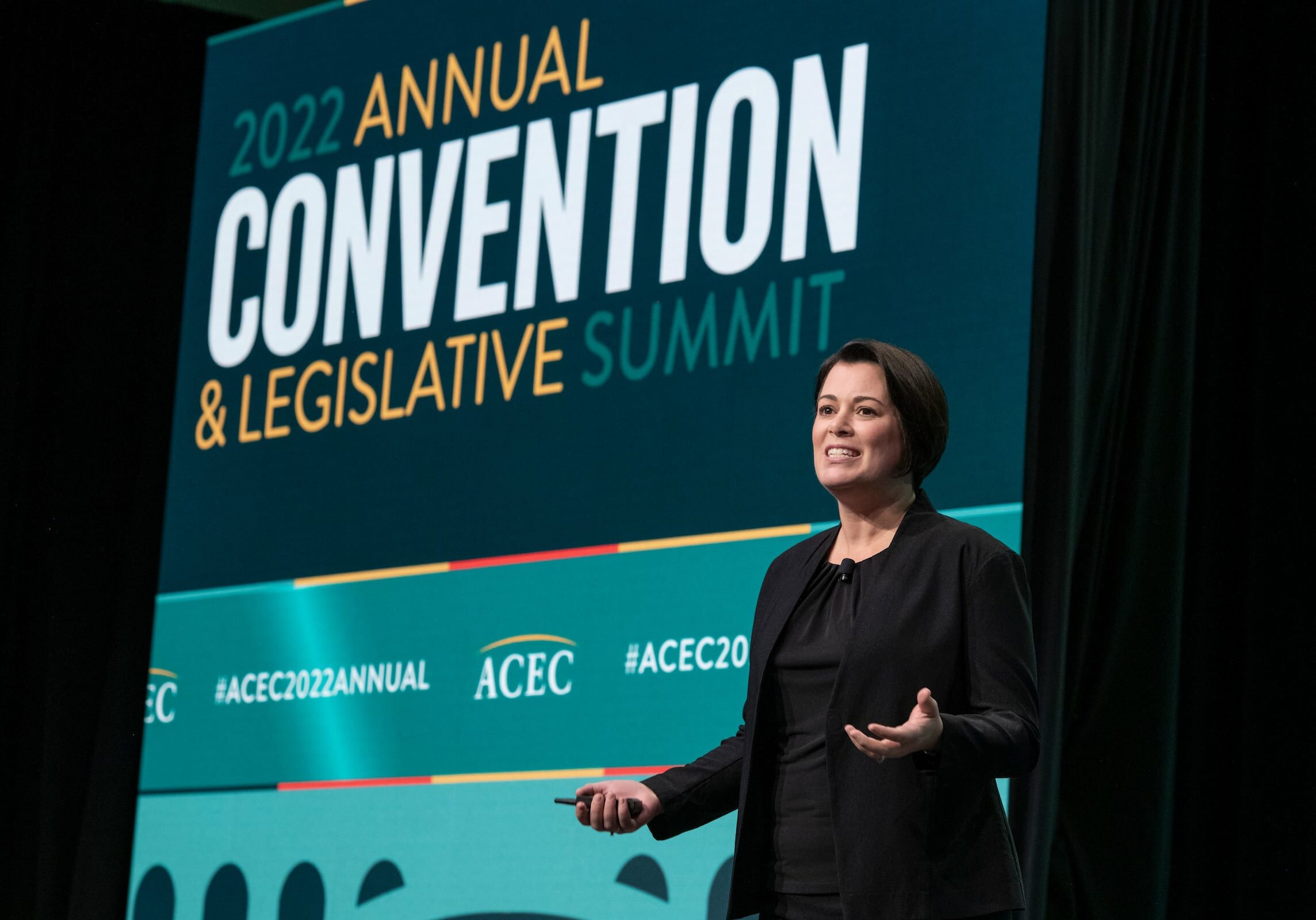 Lady speaking on the stage during the 2022 annual convention and legislative summit