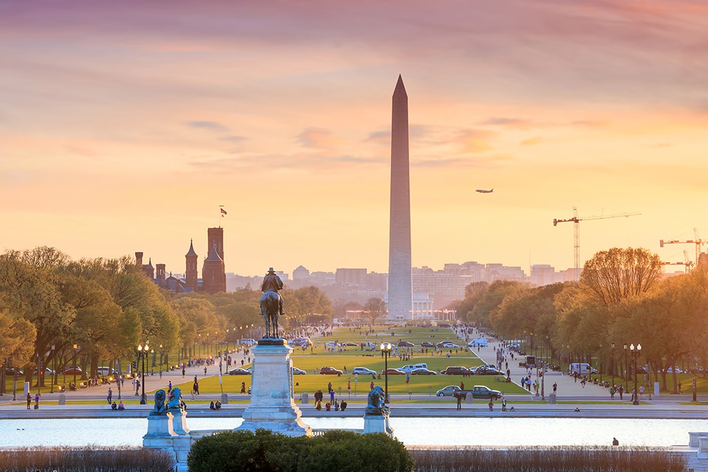 Washington DC city view at a orange sunset, including Washington Monument from Capitol building